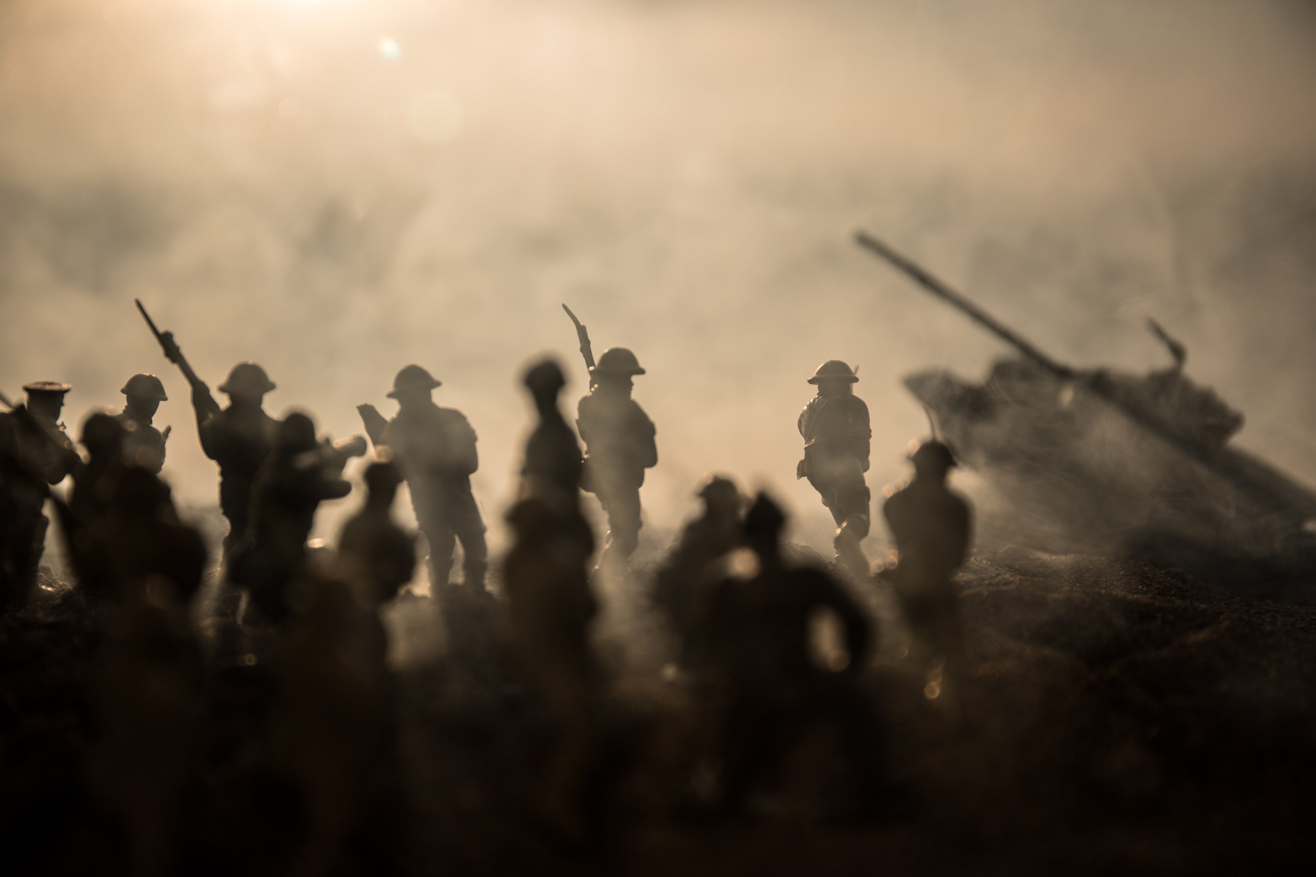 War Concept. Military silhouettes fighting scene on war fog sky background, World War Soldiers Silhouettes Below Cloudy Skyline at sunset. Attack scene. Armored vehicles.